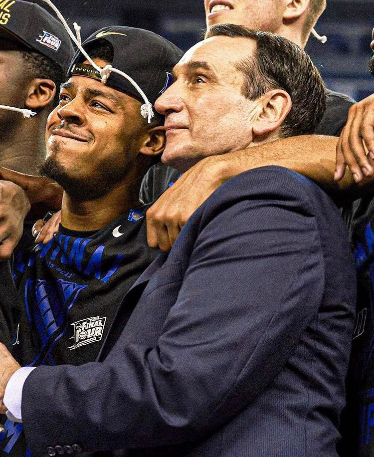 Quinn Cook celebrating with Mike Krzyzewski.