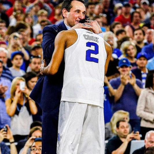 Mike Krzyzewski hugging Quinn Cook.