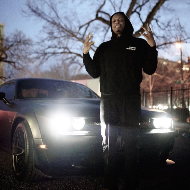 Cassius Winston posing in front of a car